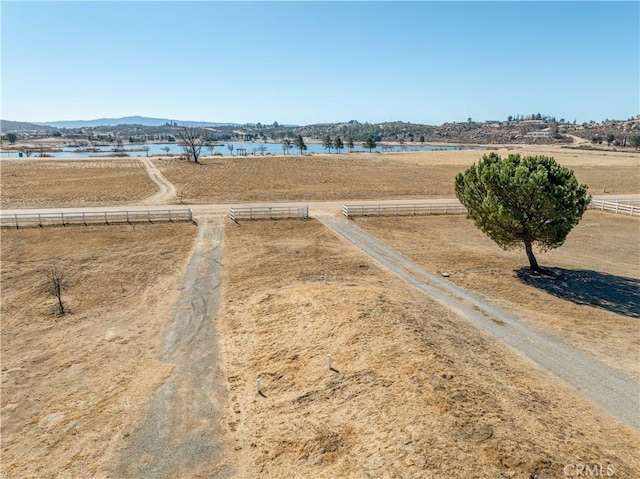 drone / aerial view featuring a water and mountain view and a rural view