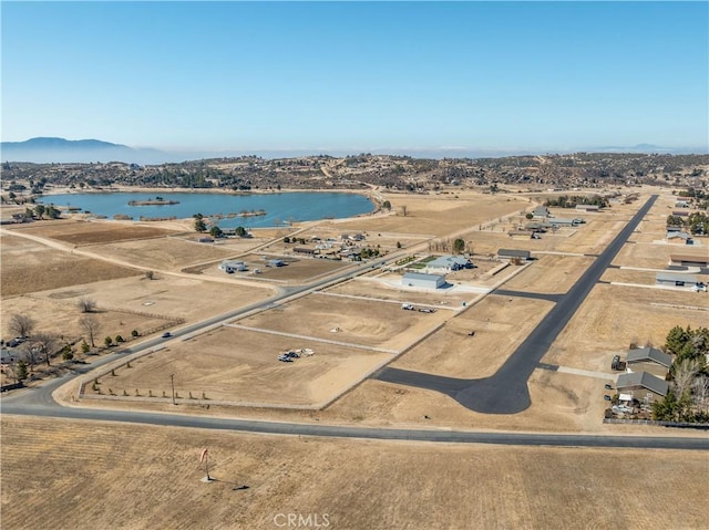 aerial view featuring a water and mountain view