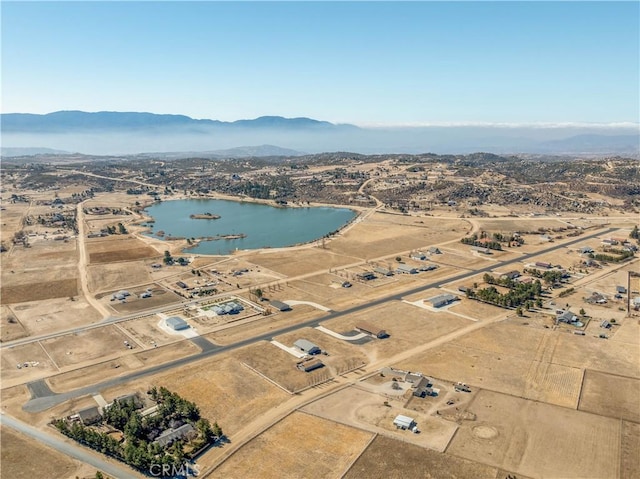 drone / aerial view featuring a water and mountain view