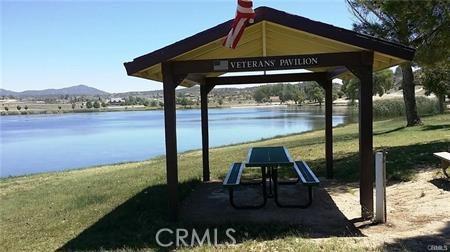 view of community with a yard, a gazebo, and a water and mountain view