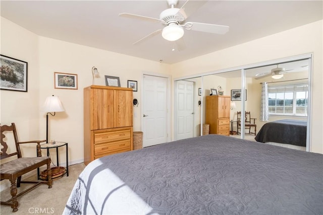 bedroom with light carpet, ceiling fan, and a closet