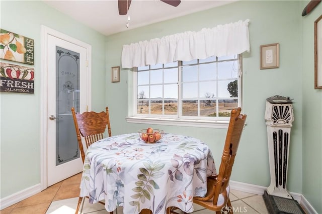 tiled dining area with ceiling fan