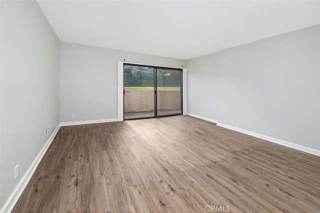 unfurnished room with hardwood / wood-style flooring