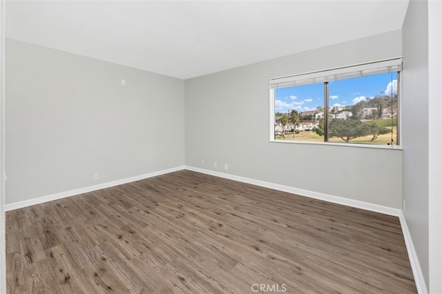 spare room featuring dark hardwood / wood-style floors