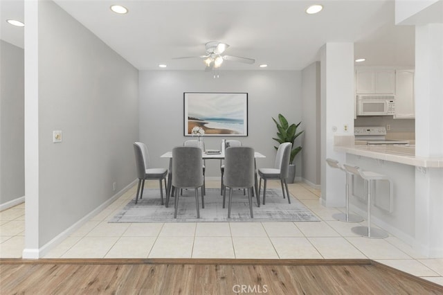 tiled dining area featuring ceiling fan