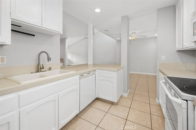 kitchen with sink, white appliances, white cabinets, and ceiling fan