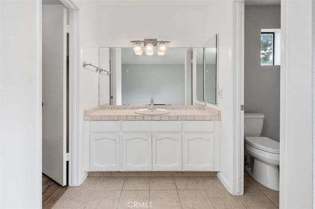 bathroom featuring tile patterned floors, toilet, and vanity