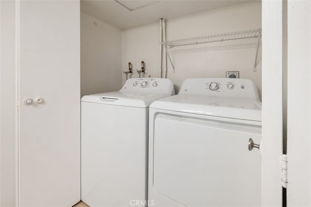 clothes washing area with washing machine and clothes dryer