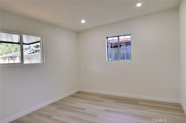 unfurnished room with light hardwood / wood-style flooring