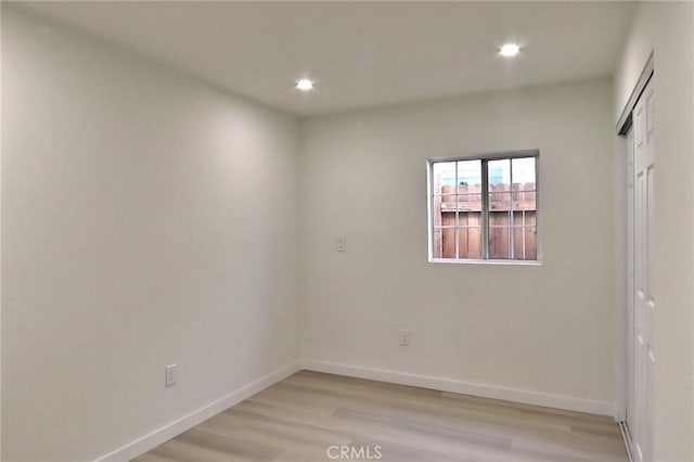 spare room with light hardwood / wood-style flooring