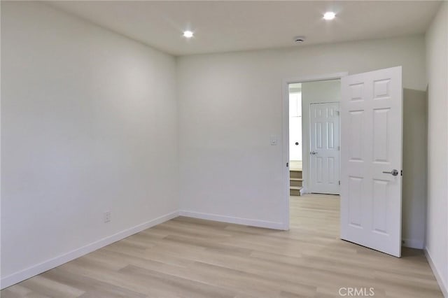 unfurnished room with light hardwood / wood-style flooring