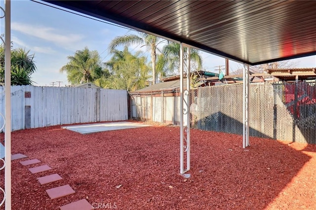 view of yard featuring a patio area and a fenced backyard