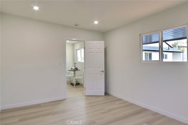 unfurnished room with light hardwood / wood-style floors