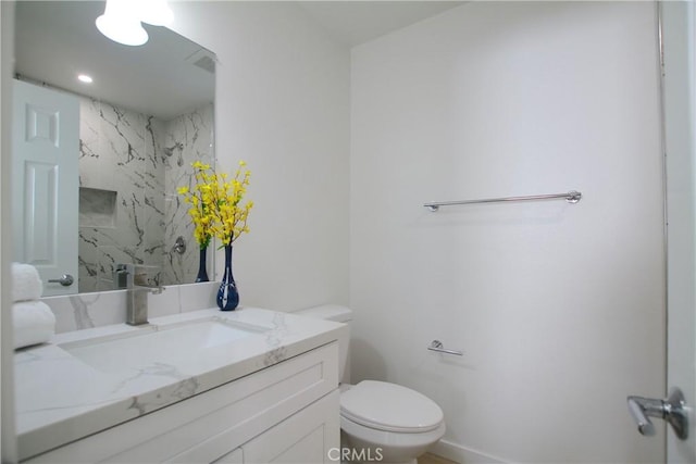 bathroom with toilet and vanity