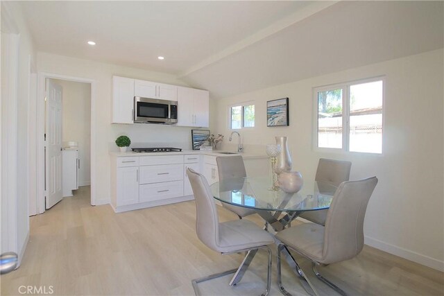 dining space with light wood-style flooring, baseboards, lofted ceiling, and recessed lighting