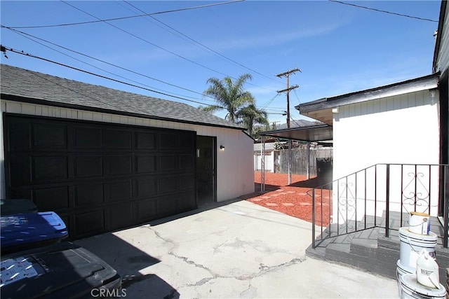 detached garage featuring fence