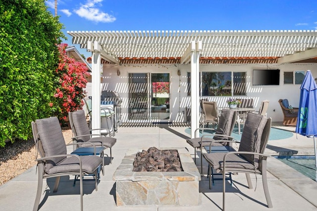 view of patio featuring an outdoor fire pit and a pergola