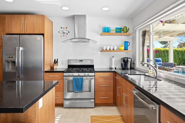 kitchen featuring sink, light tile patterned floors, appliances with stainless steel finishes, dark stone counters, and wall chimney exhaust hood