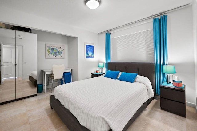 bedroom featuring a closet and light tile patterned floors