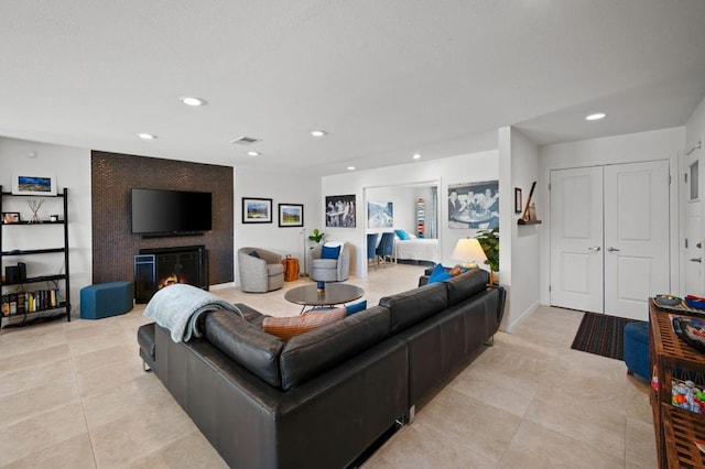 living room featuring light tile patterned floors and a fireplace