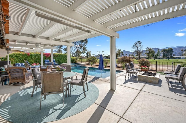 view of patio with a mountain view, a pergola, a fenced in pool, and an outdoor fire pit