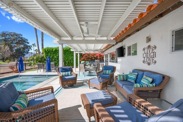 view of patio with a fenced in pool, outdoor lounge area, and ceiling fan