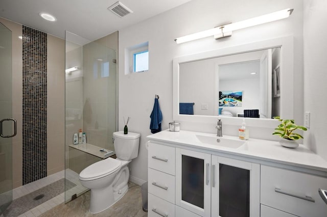 bathroom featuring vanity, an enclosed shower, and toilet