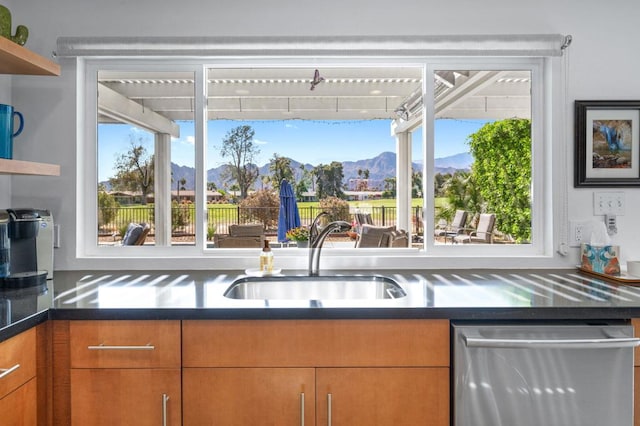 kitchen with dishwasher, a mountain view, sink, and plenty of natural light