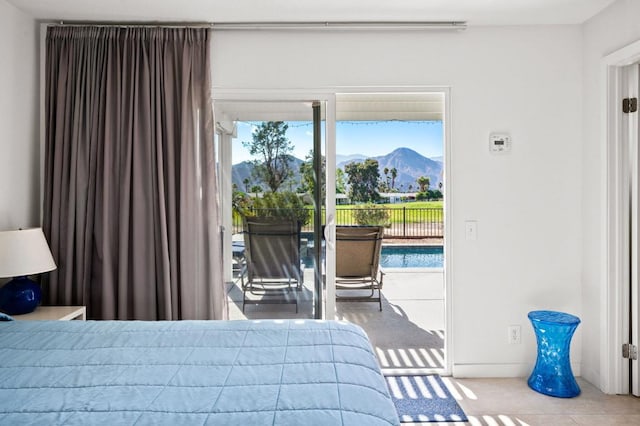 bedroom with a mountain view and access to outside