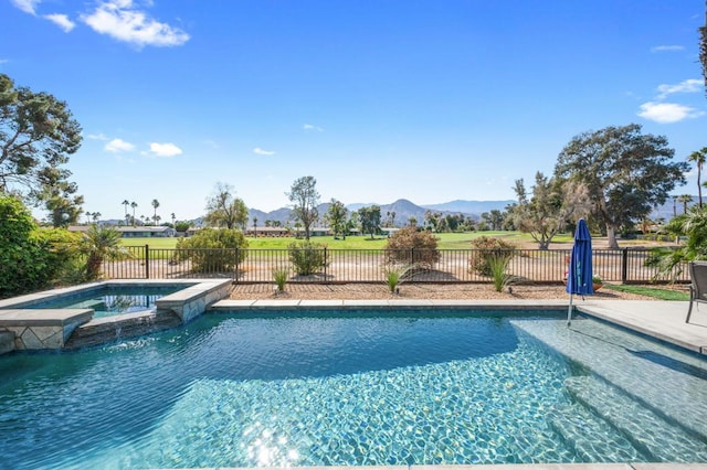 view of swimming pool featuring an in ground hot tub and a mountain view