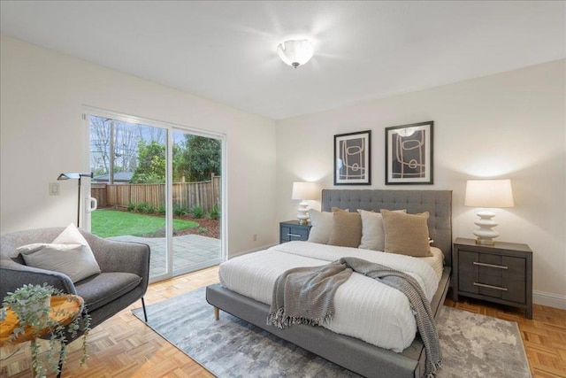 bedroom with light parquet floors and access to exterior