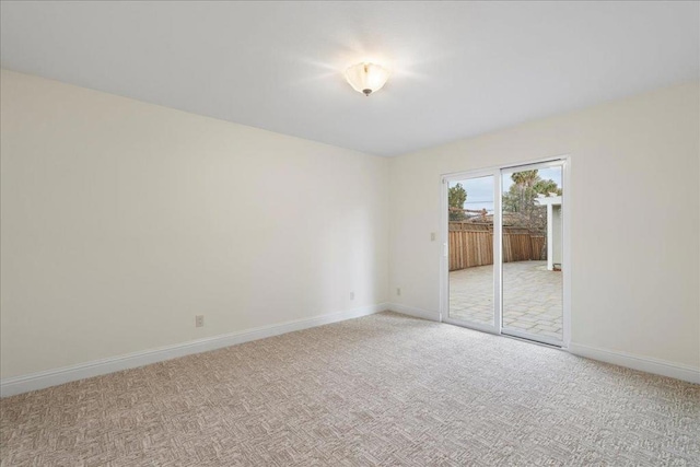 unfurnished room featuring light carpet