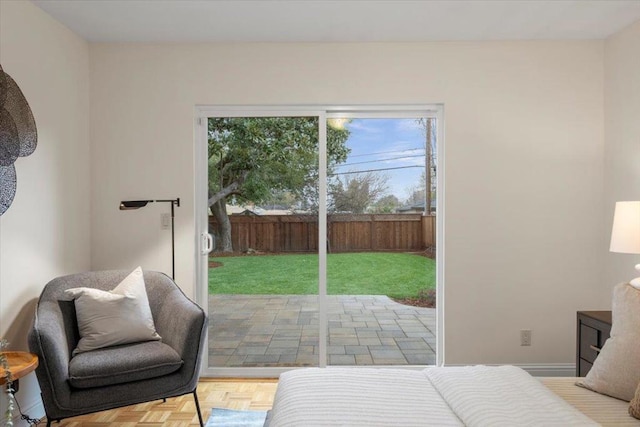 bedroom featuring light parquet flooring and access to outside