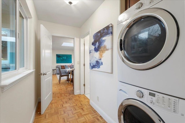 washroom with stacked washer and dryer and light parquet floors