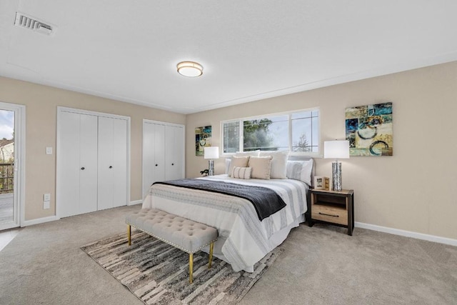 carpeted bedroom with two closets