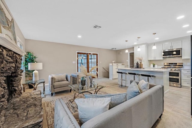 living room with a stone fireplace