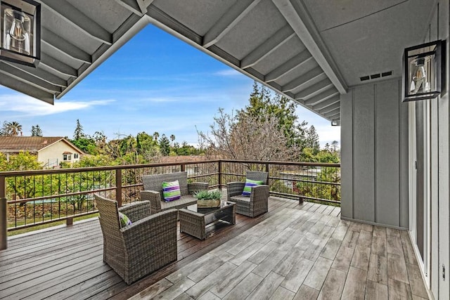 wooden terrace with an outdoor hangout area