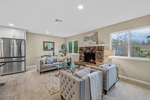 living room featuring a stone fireplace