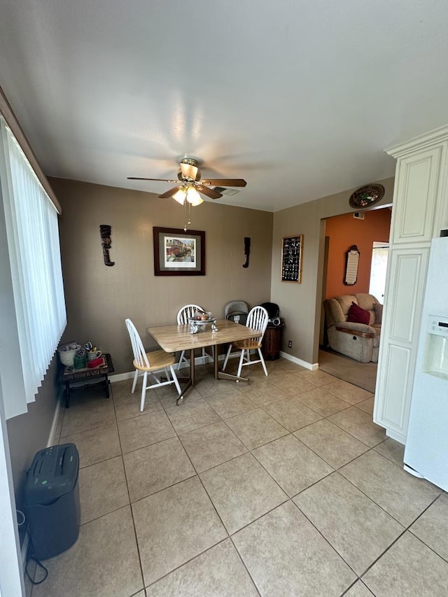 tiled dining room featuring ceiling fan