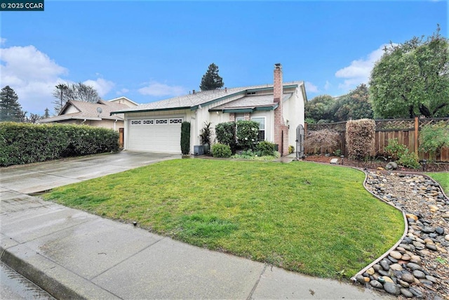 view of front of home featuring a garage and a front lawn