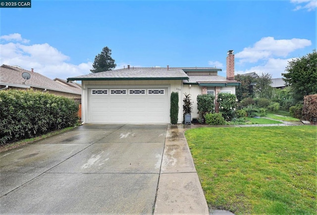 view of front of home with a garage and a front lawn