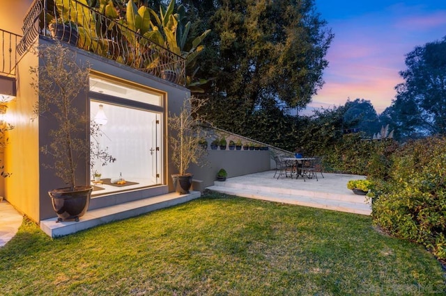 yard at dusk with a patio area