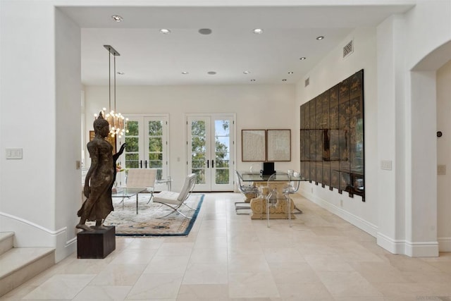 unfurnished living room featuring french doors and light tile patterned flooring