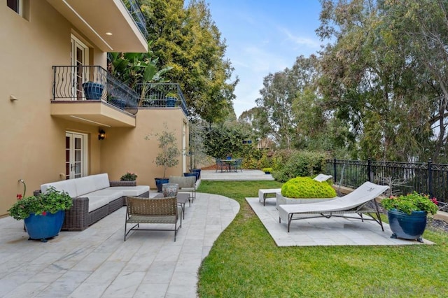 view of yard with a balcony, outdoor lounge area, and a patio area