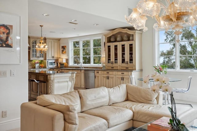 living room with sink and a notable chandelier