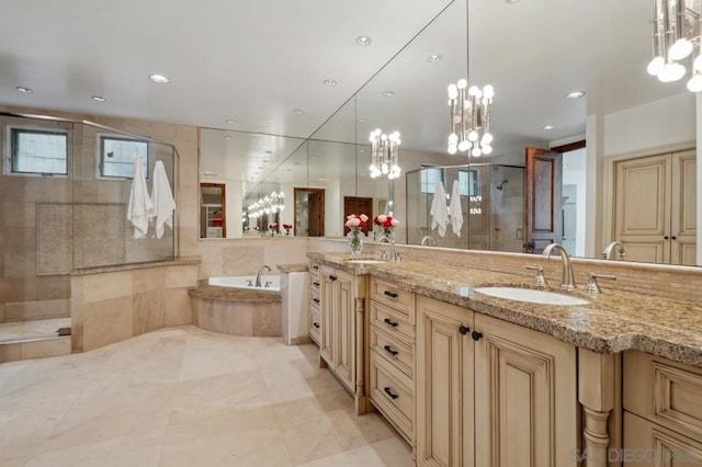 bathroom with vanity and shower with separate bathtub