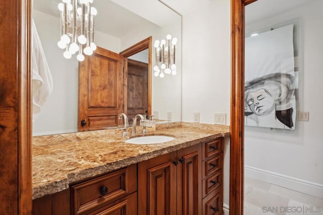 bathroom with vanity and a notable chandelier