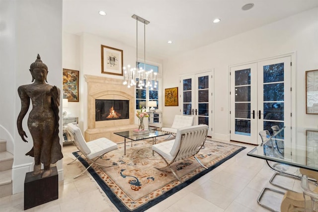 living room with light tile patterned floors, a high end fireplace, french doors, and a chandelier