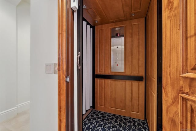 doorway featuring wood ceiling and elevator