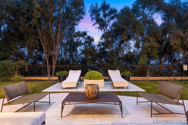 patio terrace at dusk featuring an outdoor hangout area